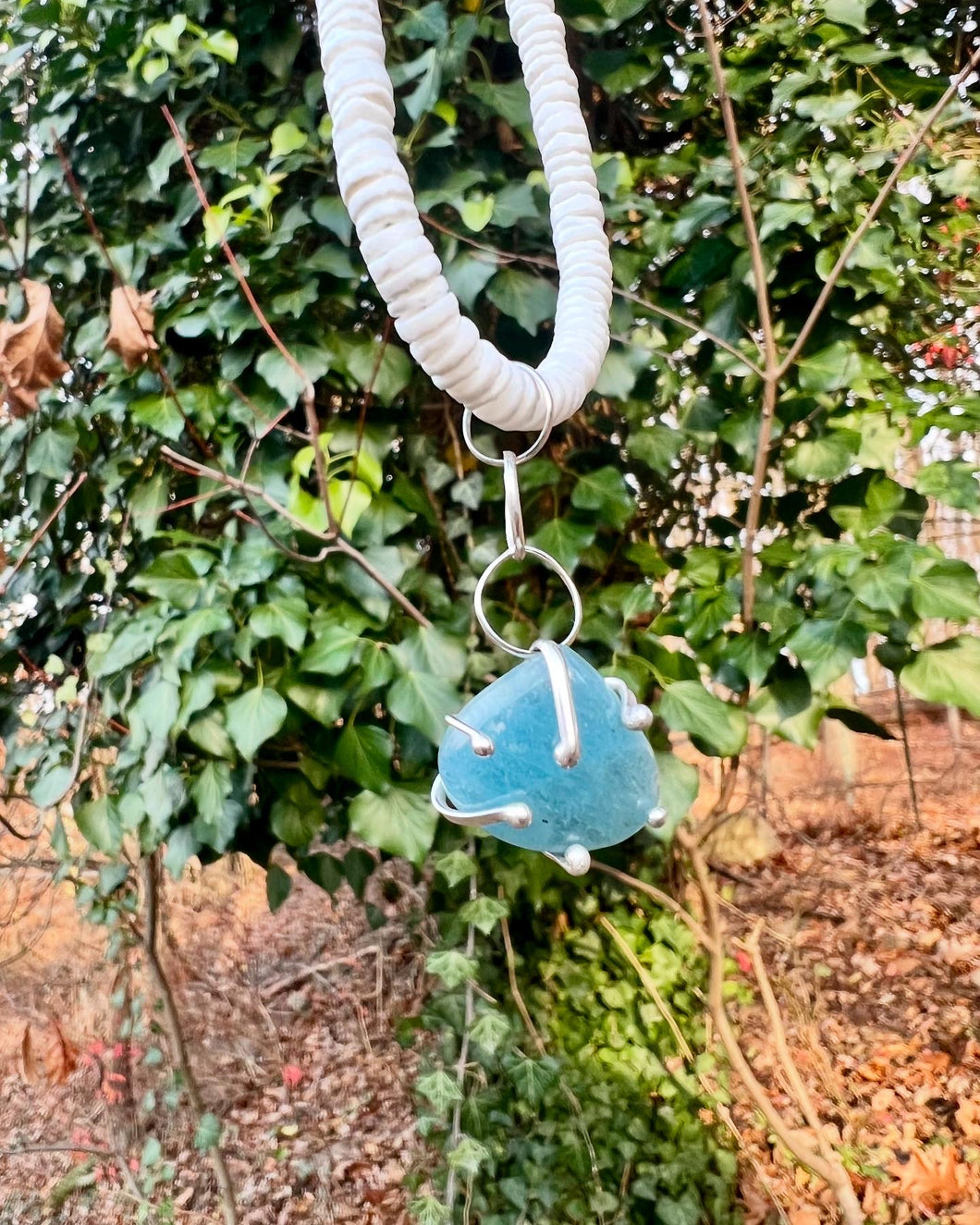 Aquamarine in Sterling silver on a shell necklace (14 inches)